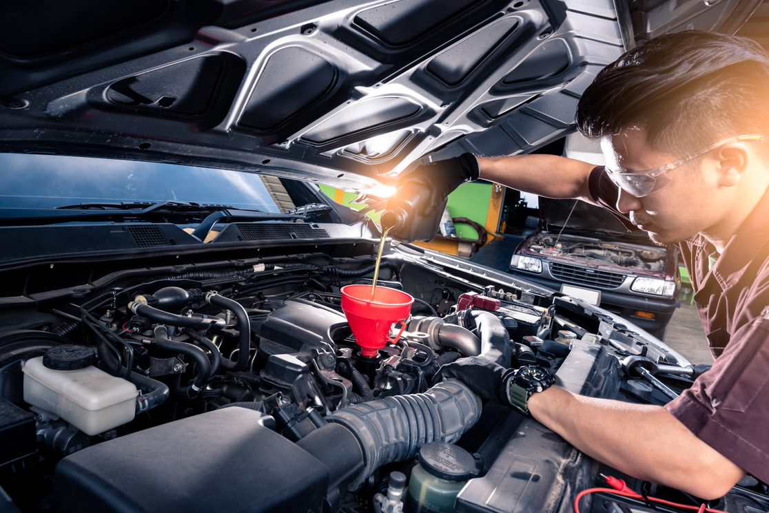 A mechanic completing an oil change